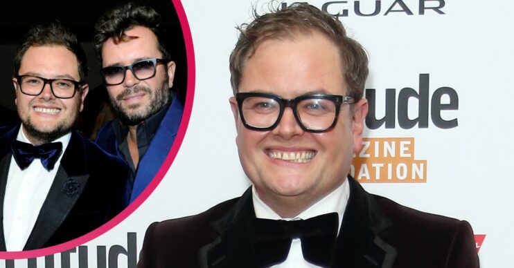Alan Carr smiling in a suit next to former husband Paul Drayton