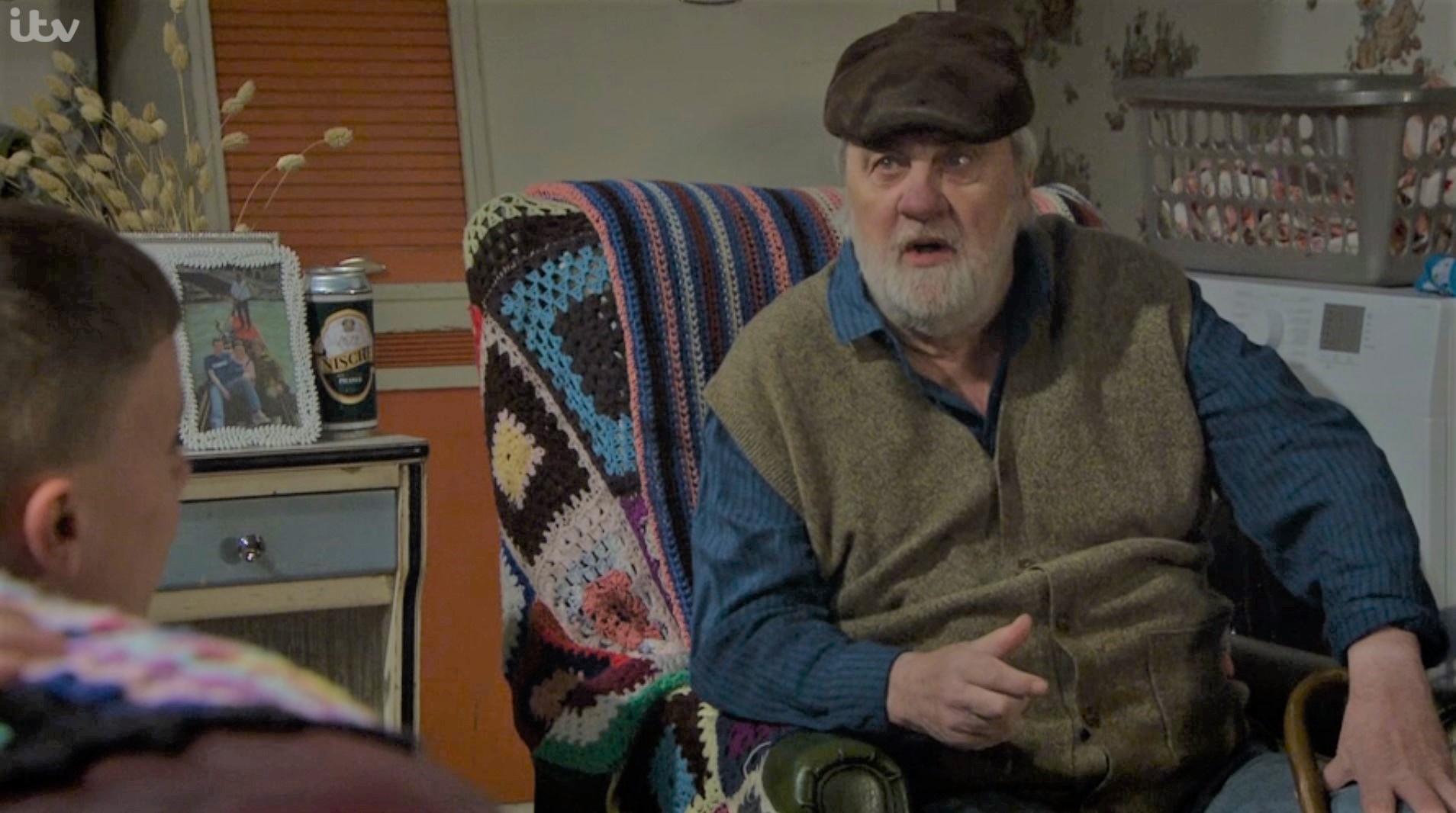 Zak Dingle in Emmerdale sits in his chair looking angry