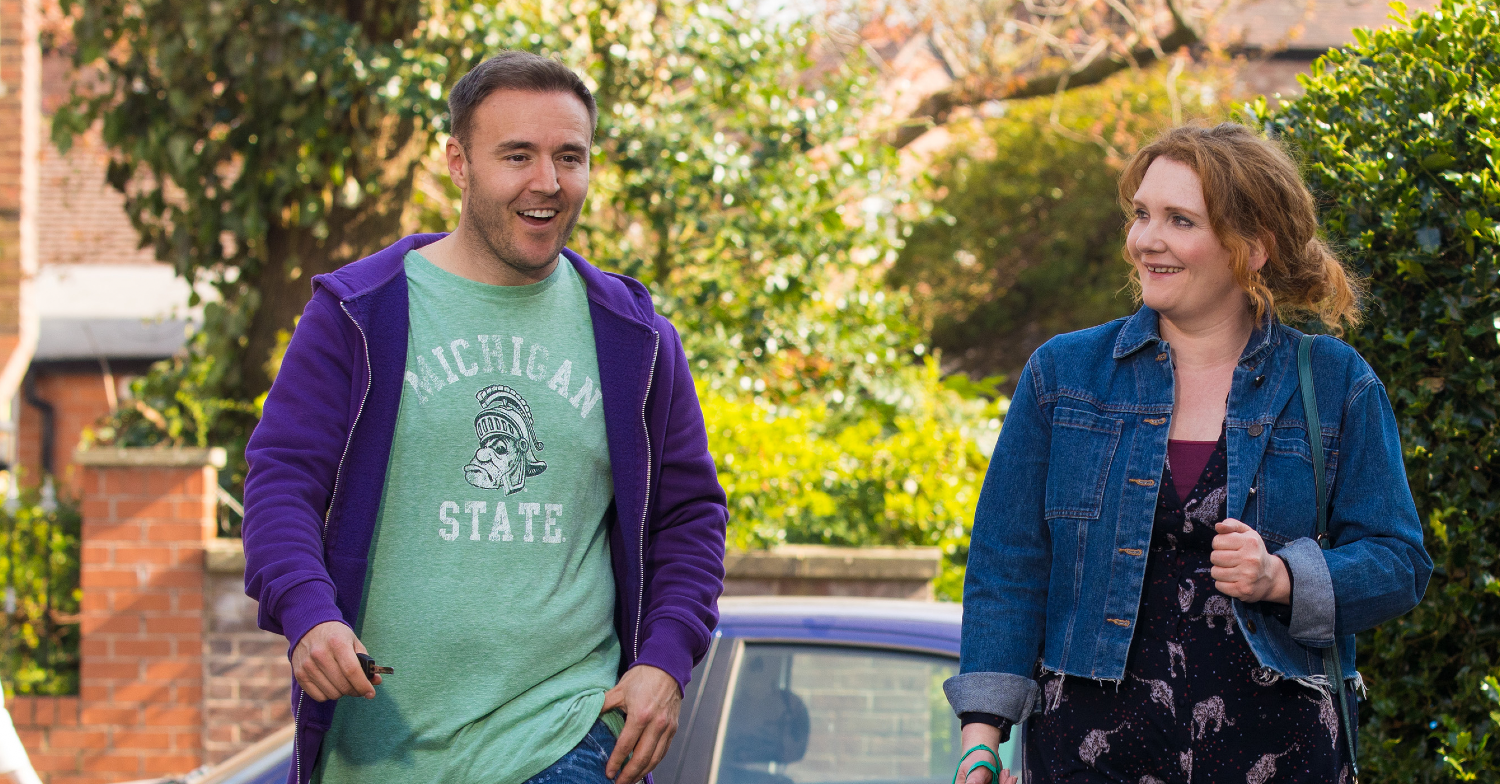 Coronation Street Fiz and Tyrone walking down the street smiling
