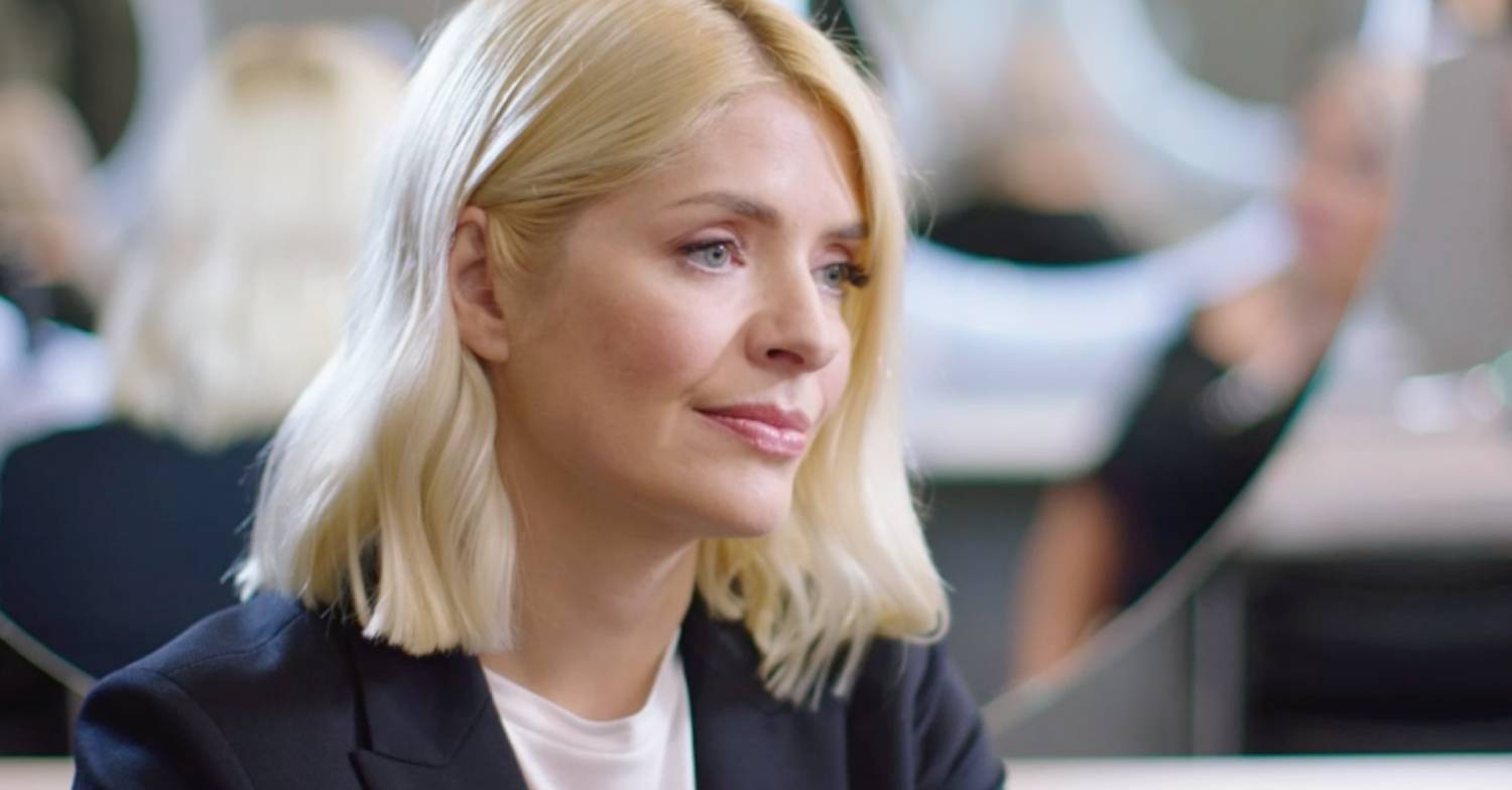 Holly Willoughby listens intently