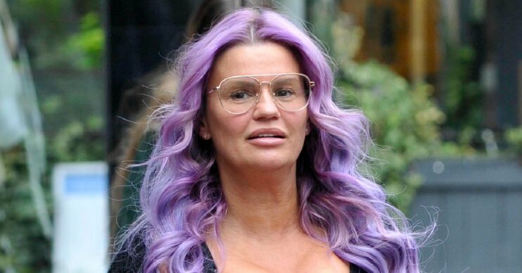 Kerry Katona with purple hair looking concerned