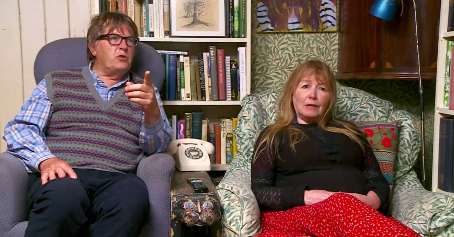 Giles points at the TV while speaking to Mary on Gogglebox