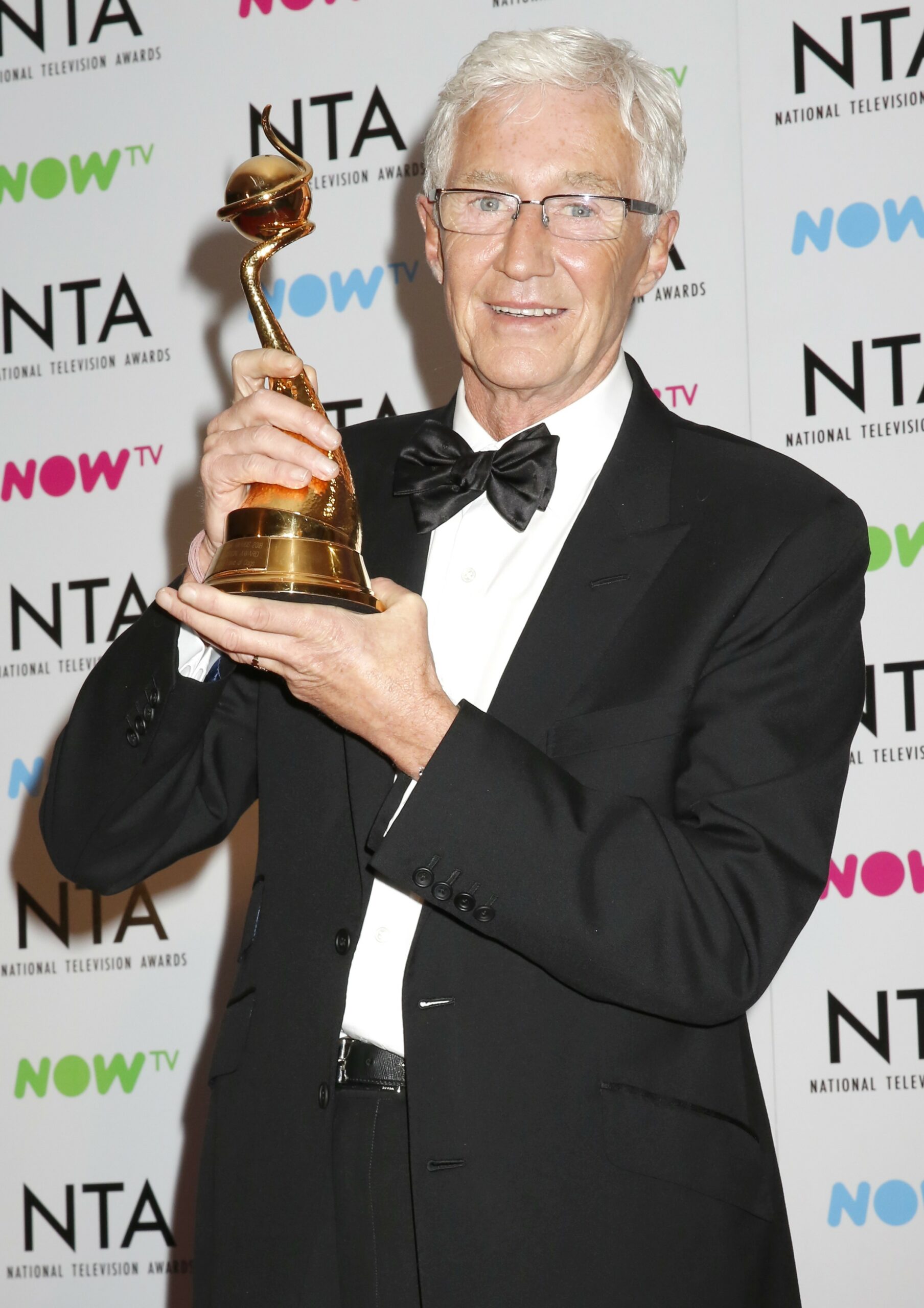 Paul O'Grady holds up award at NTAs