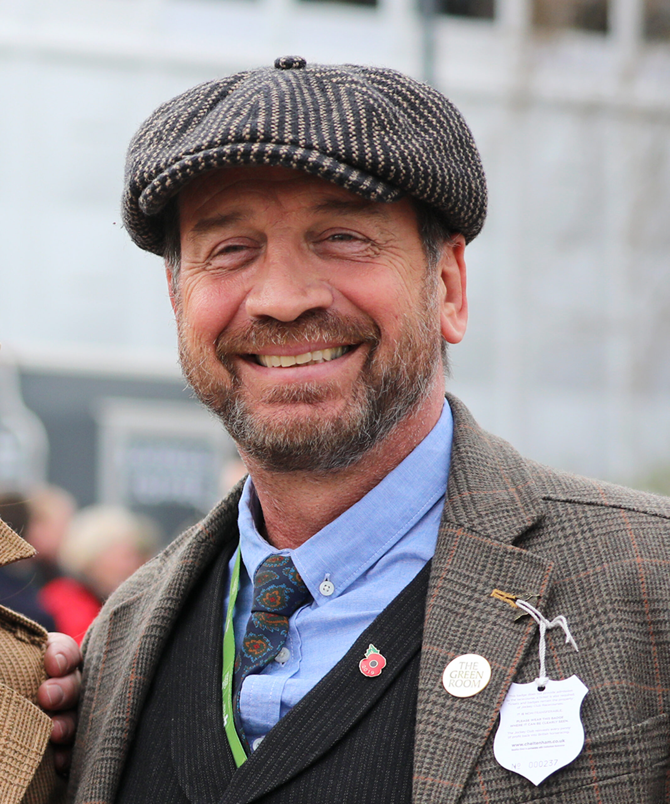 Nick Knowles grinning in a flat cap