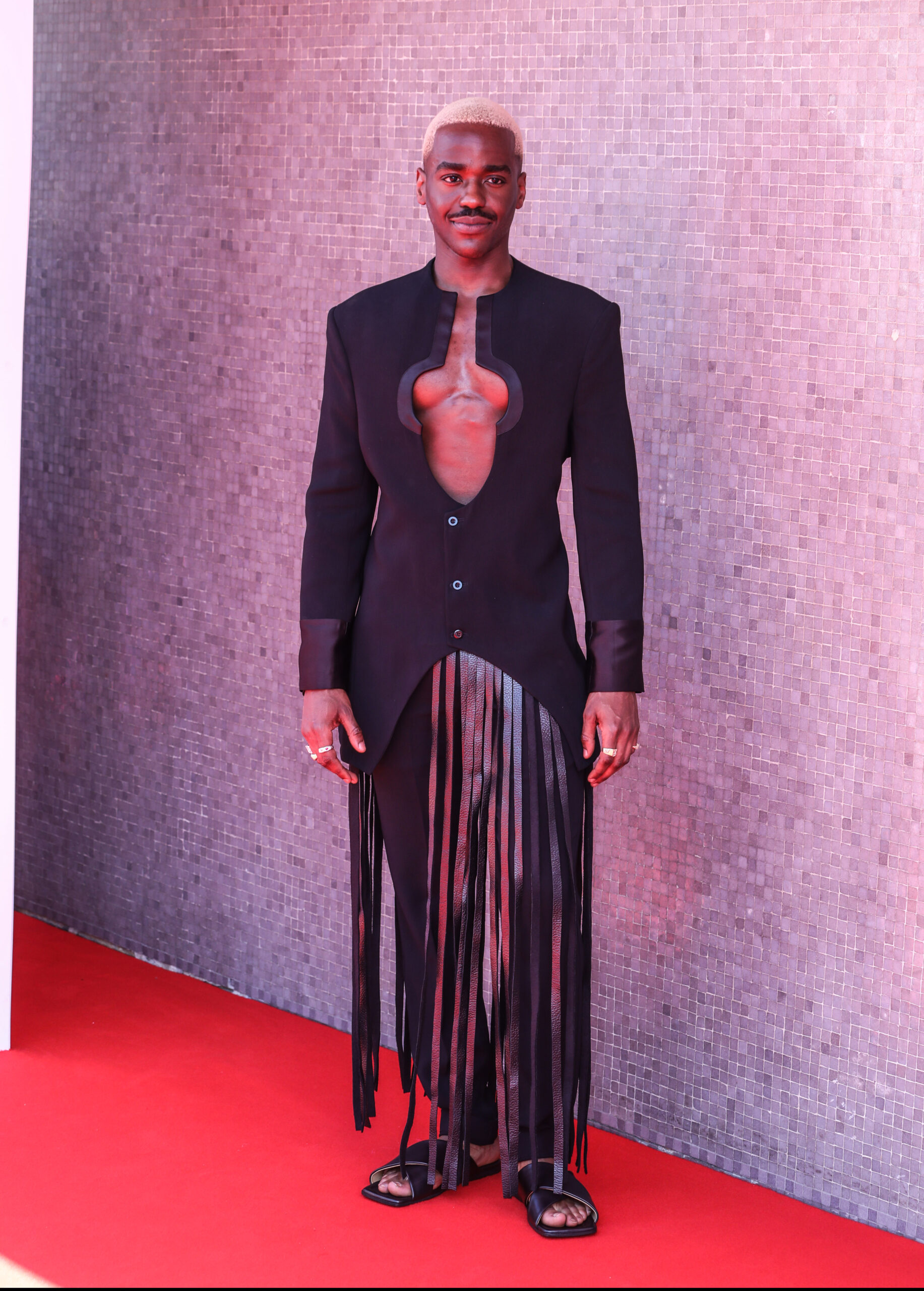 Ncuti Gatwa wearing an open jacket with bare chest
