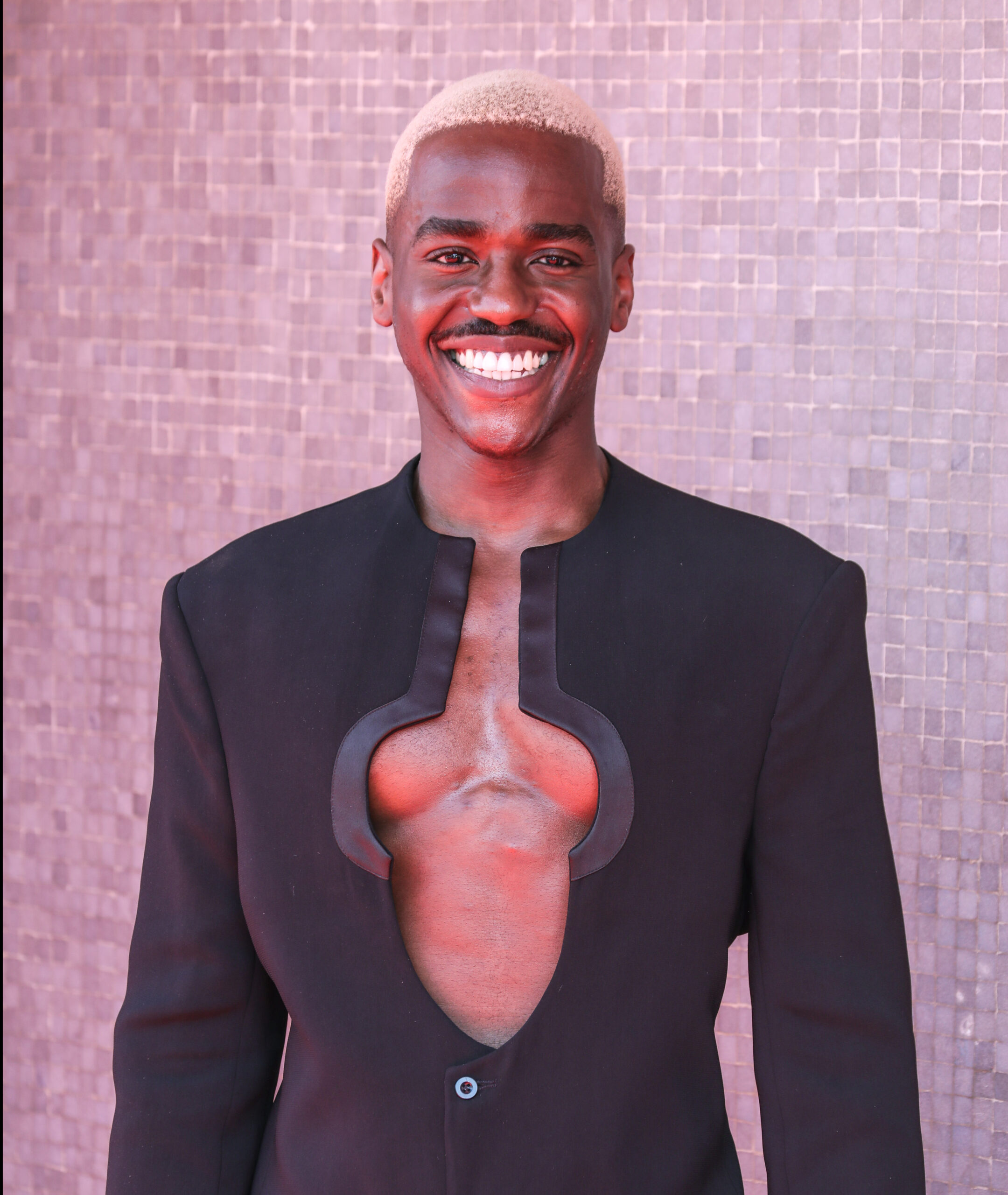 Ncuti Gatwa smiling on the red carpet of the Baftaas