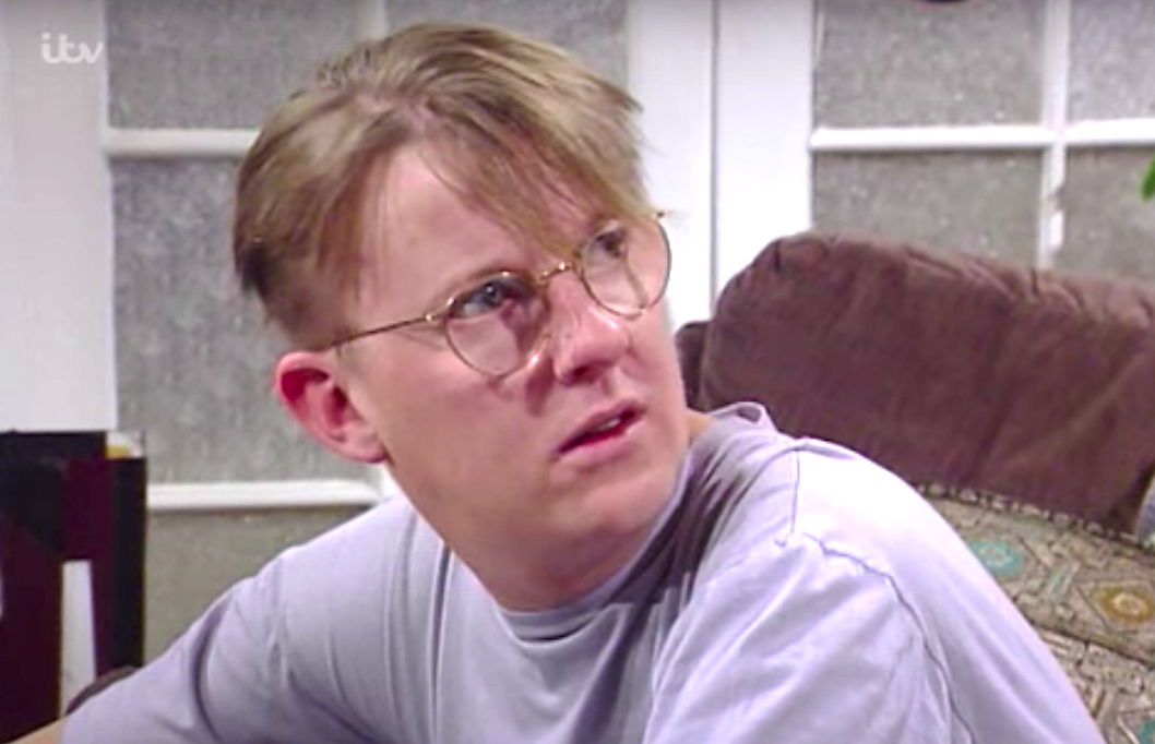 Curly Watts looks annoyed in Coronation Street