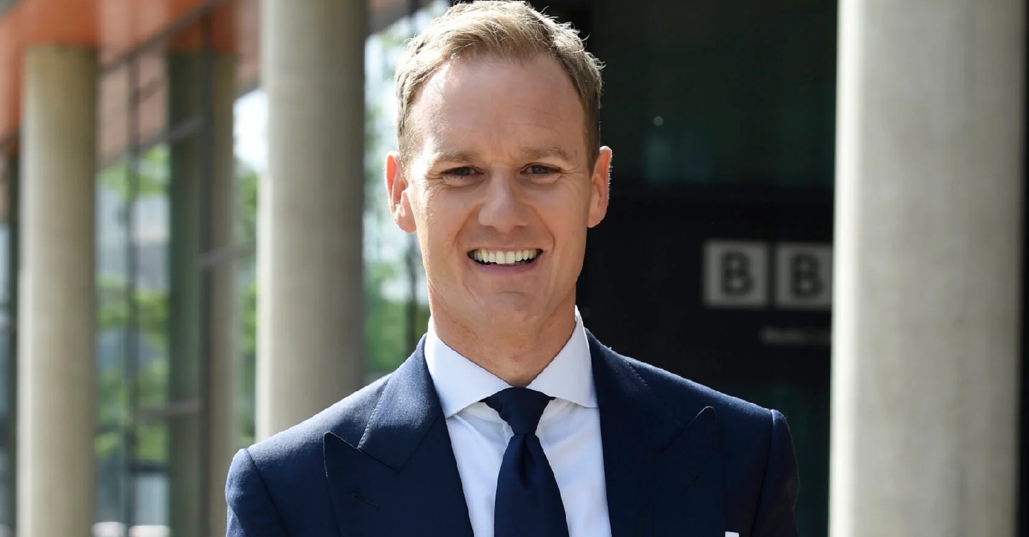 Dan Walker smiling in a suit