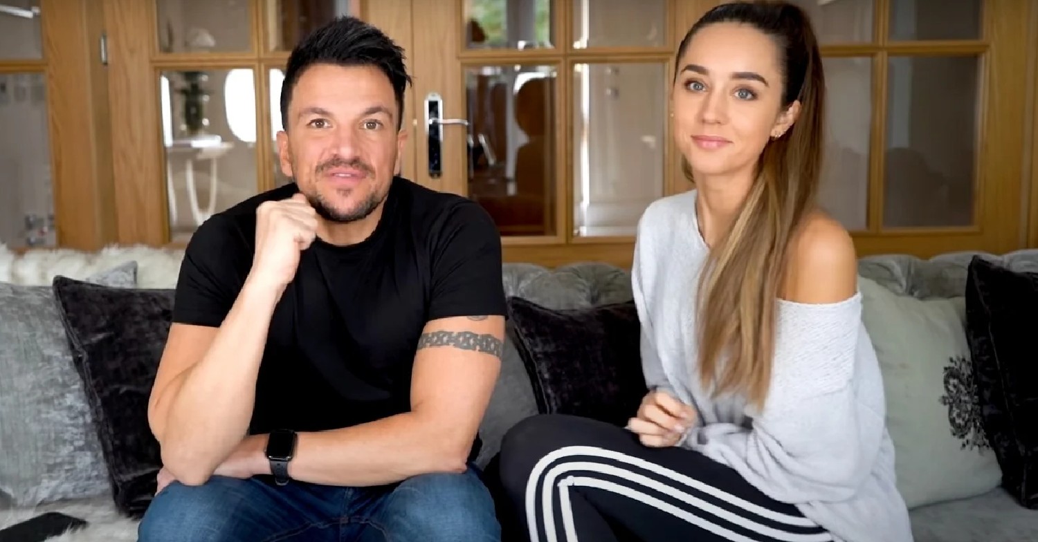 Peter Andre and Emily Andre sitting on a sofa, speaking to camera
