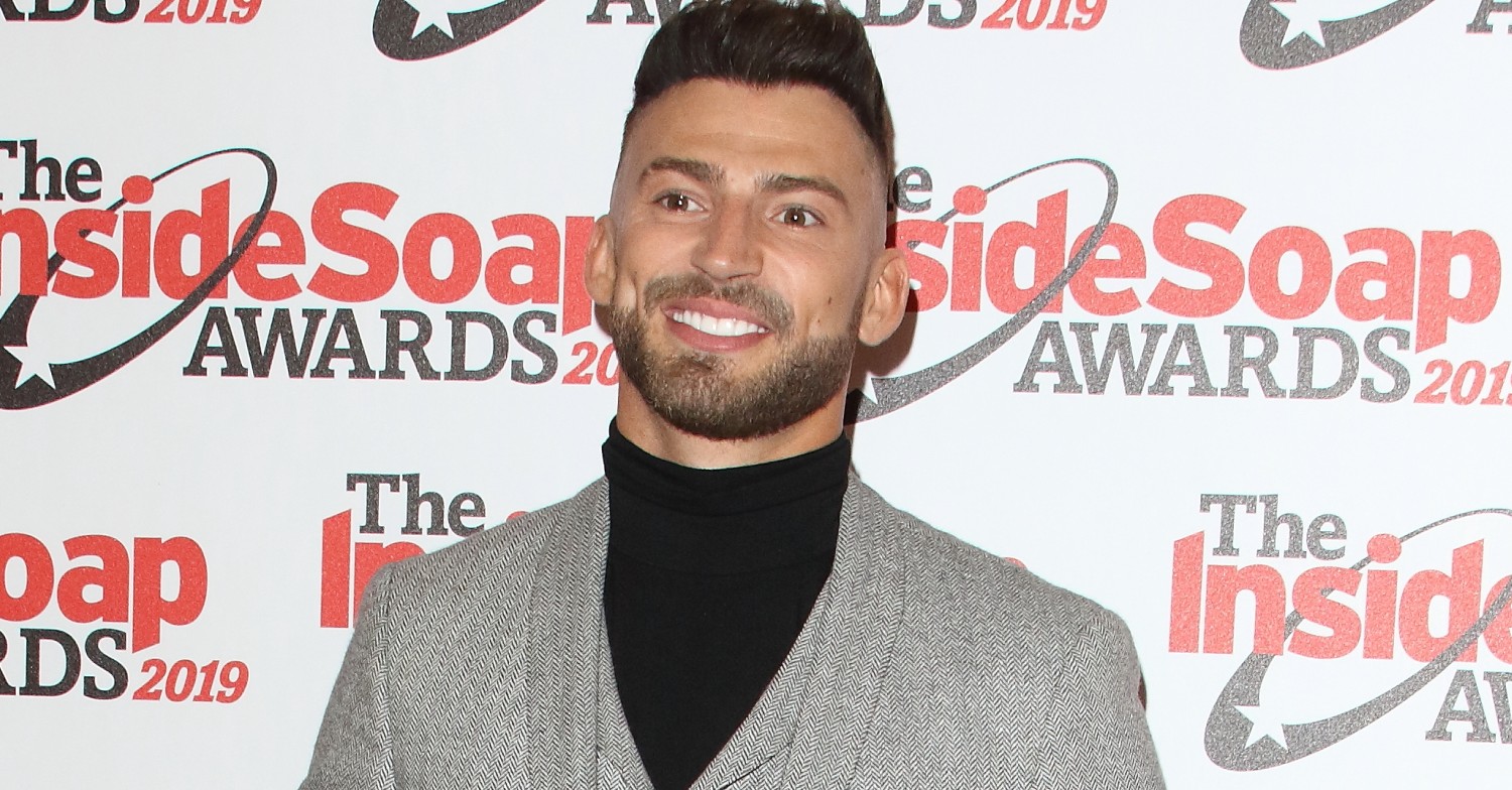 Jake Quickenden wearing a turtleneck and smiling