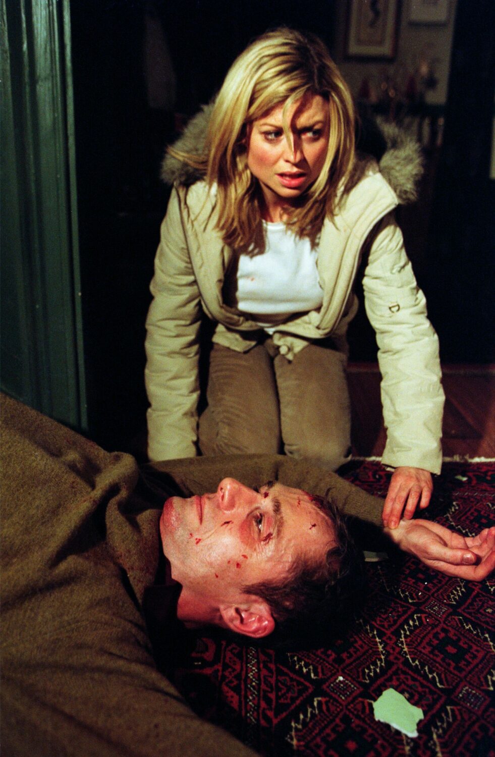Frightened Louise Appleton in Emmerdale takes Ray's pulse after pushing him down the stairs