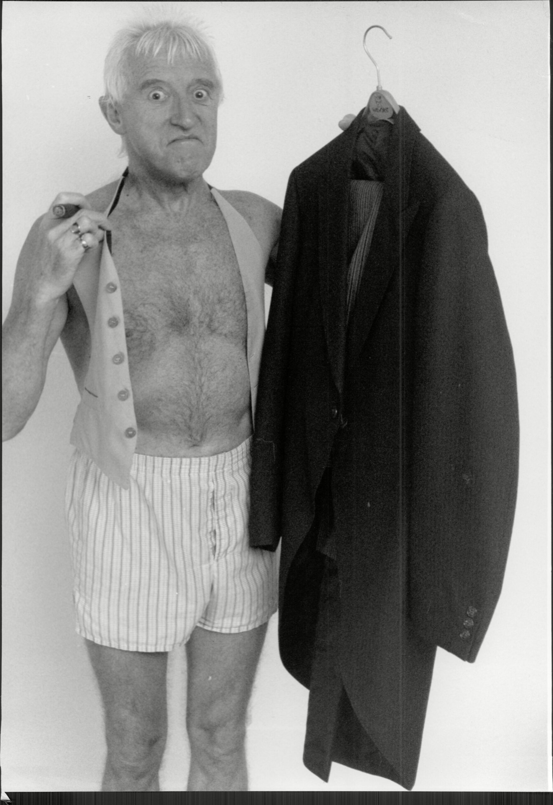 Jimmy Savile poses with the suit he wore to be Knighted
