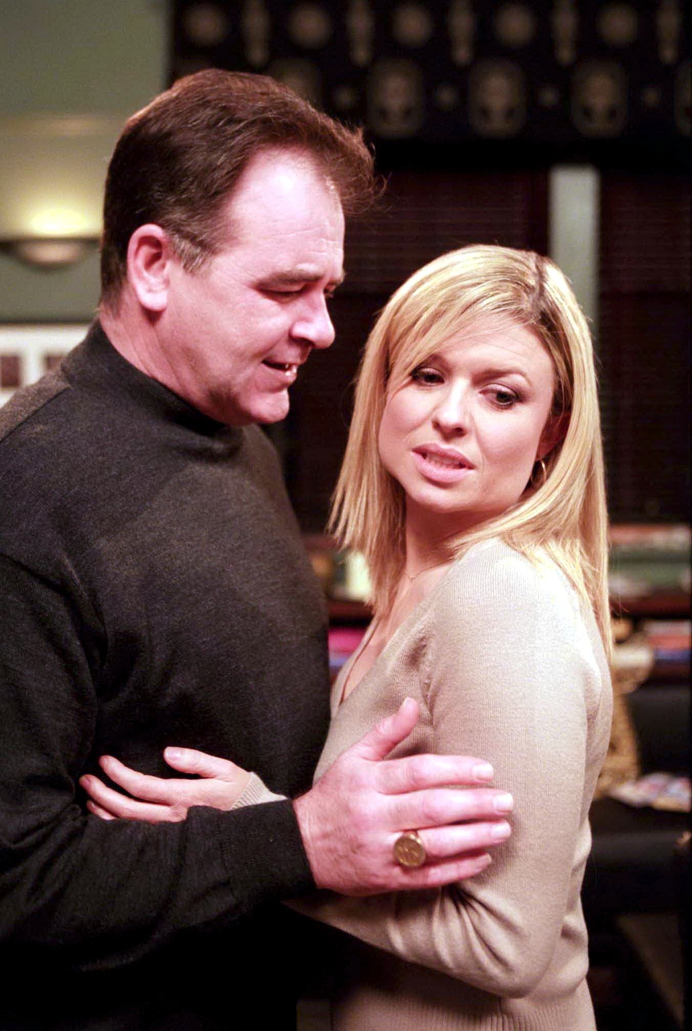 Emmerdale Terry smiles as he holds Louise by the arms, but she looks away pained