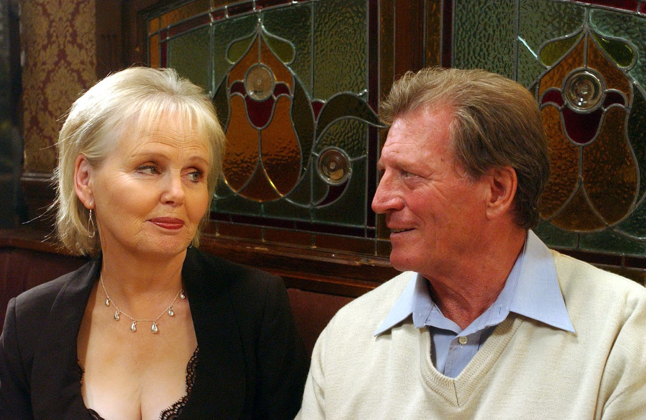 Viv Baldwin and Mike Baldwin in Coronation Street look knowingly at each other