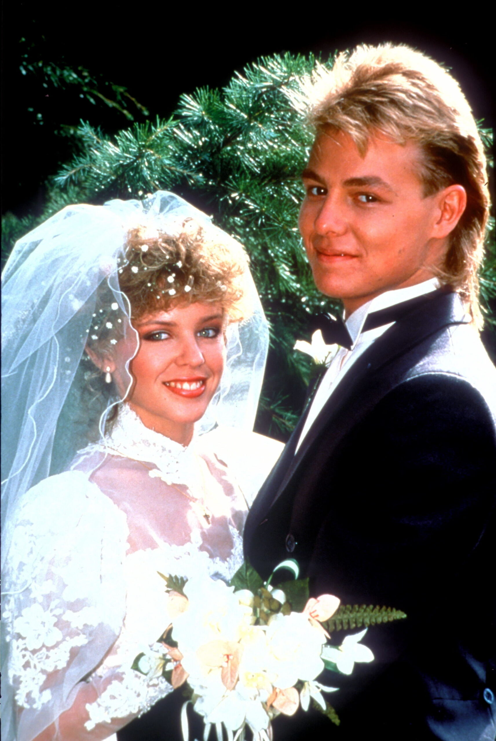 Neighbours Charlene and Scott smile happily for their wedding picture