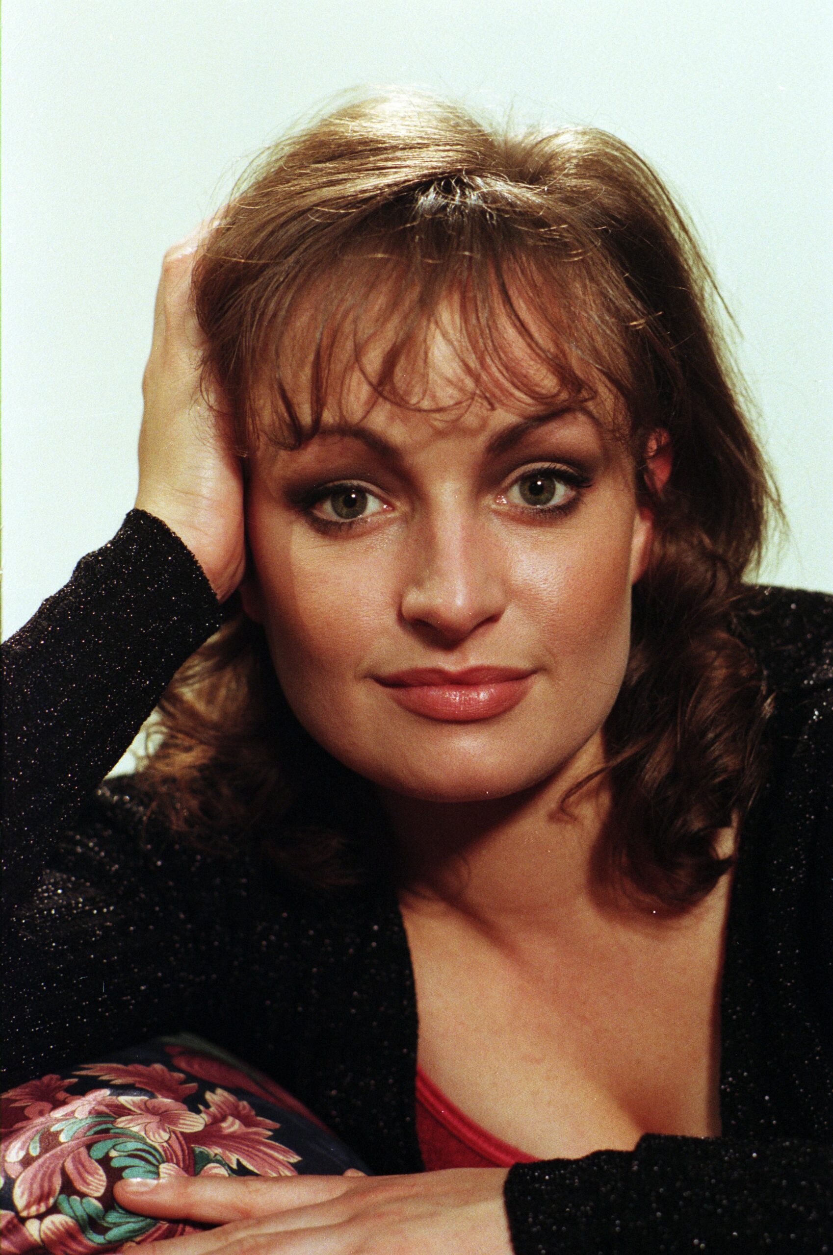 Tina Dingle poses for the camera leaning her head on her hand in Emmerdale