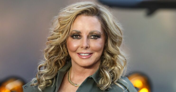 Carol Vorderman smiles with curly hair at Top Gun premiere