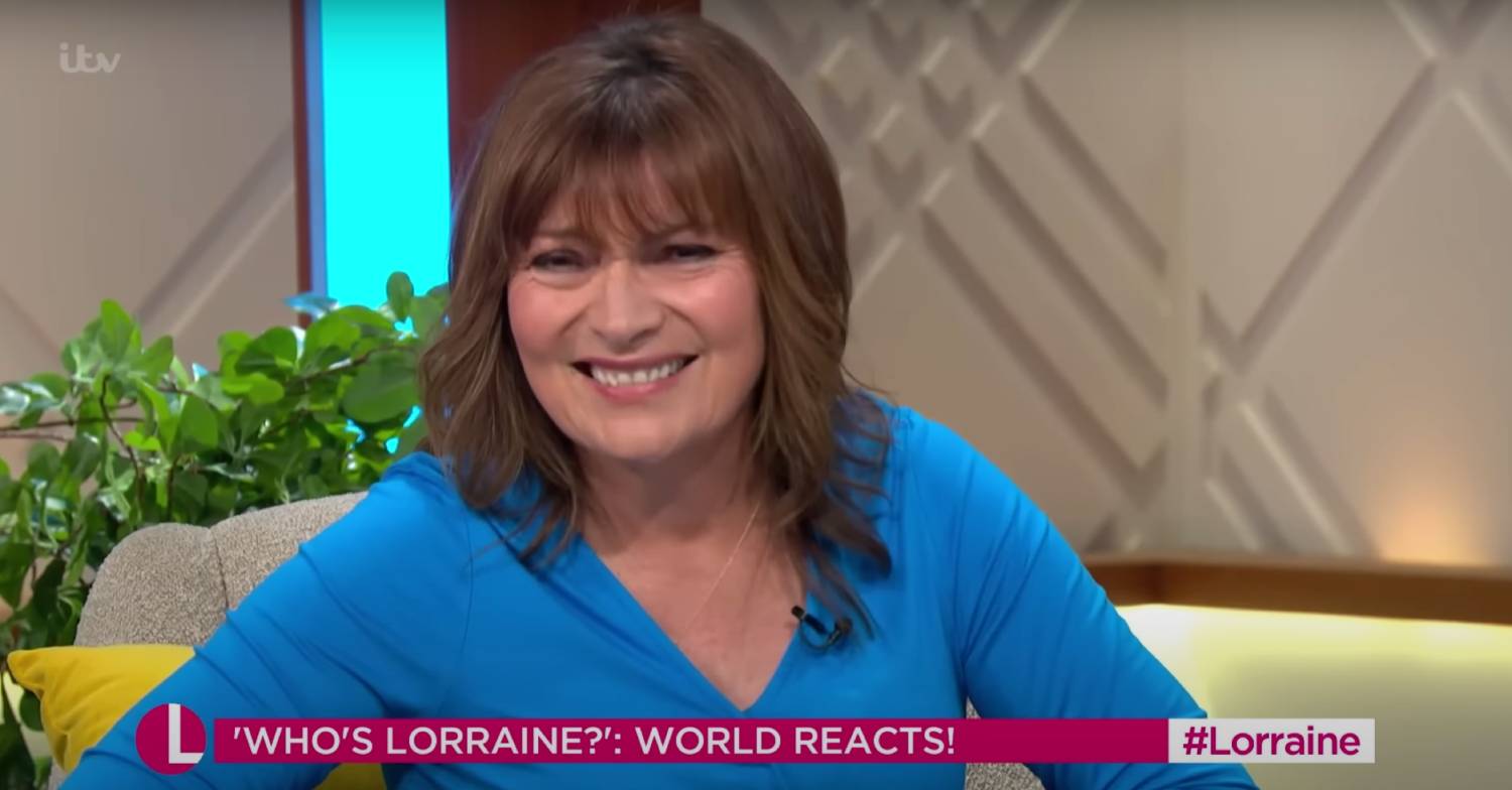 Lorraine Kelly laughing on her show in blue dress
