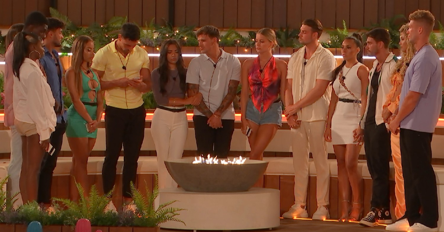 Love Island stars gathering around the firepit