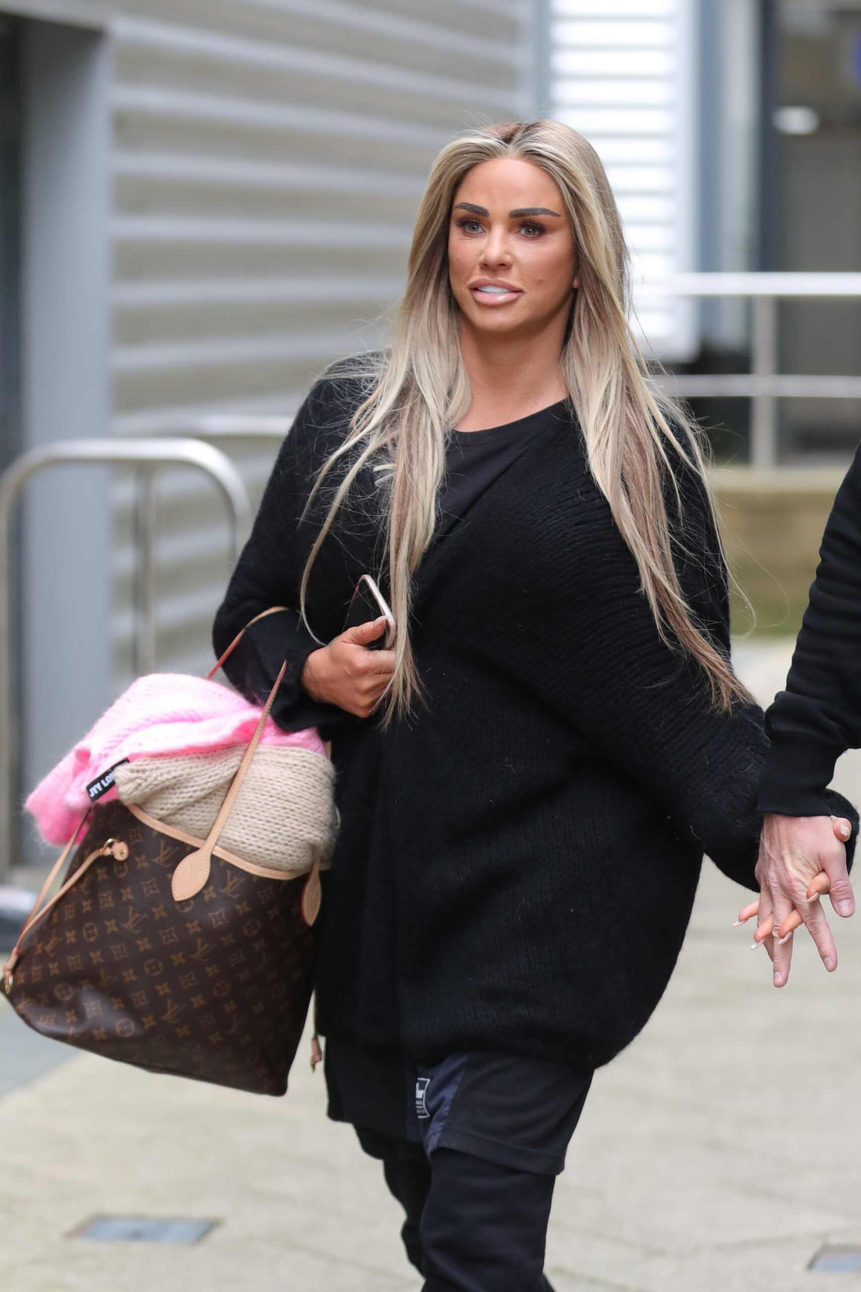 Katie Price holding a bag with long blonde hair