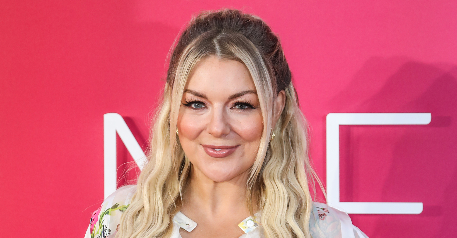Sheridan Smith smiling with her hair half up and half down