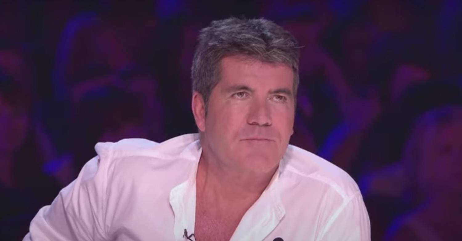 Simon Cowell listens to Tom Mann during his X Factor audition