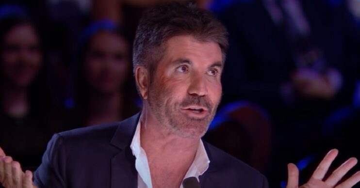 Simon Cowell with his hands up on BGT final