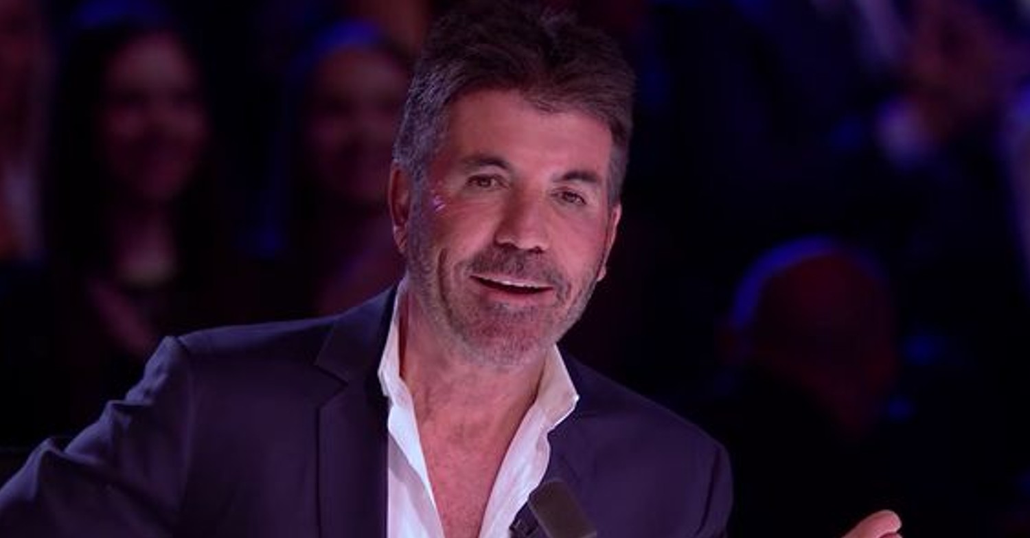 Simon Cowell smiling while talking on BGT