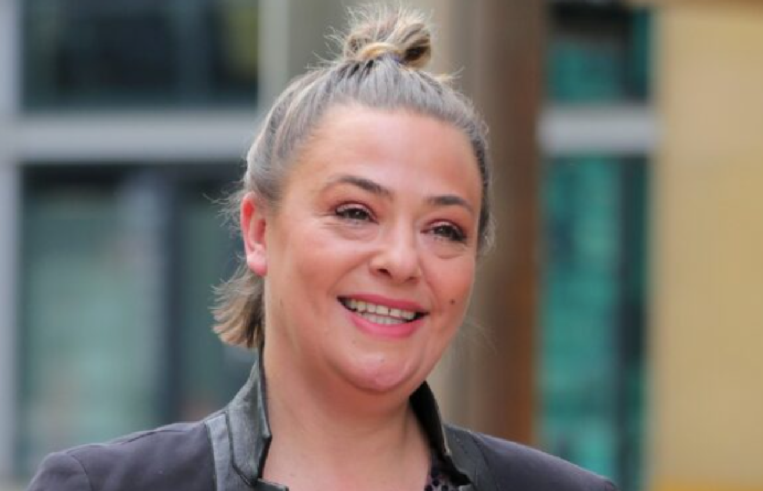 Lisa Armstrong is all smiles with her hair in a bun