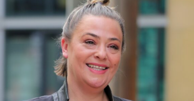 Lisa Armstrong is all smiles with her hair in a bun