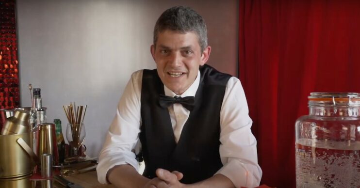 Merlin Griffiths wearing a waistcoat and bow tie, smiling