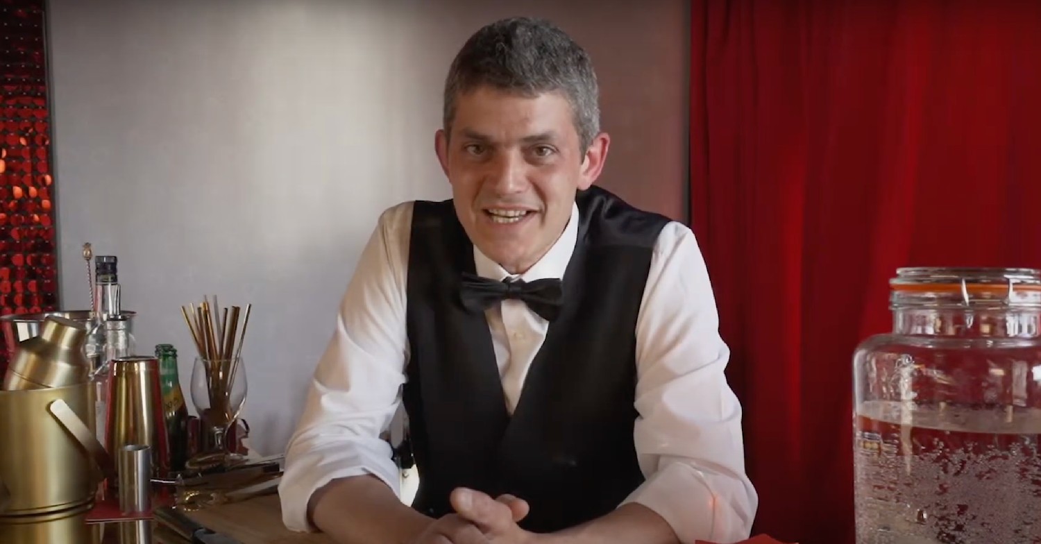 Merlin Griffiths wearing a waistcoat and bow tie, smiling