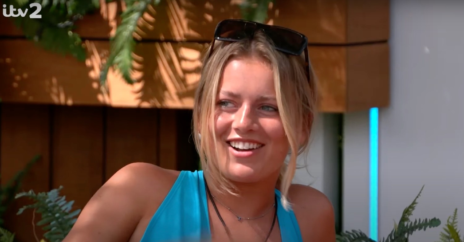 Tasha smiling in blue swimsuit on Love Island 