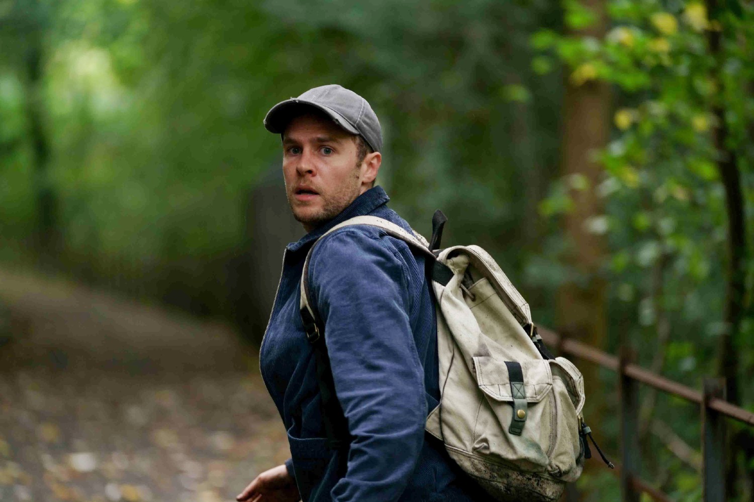 Ian De Caestecker running away in the woods in The Control Room