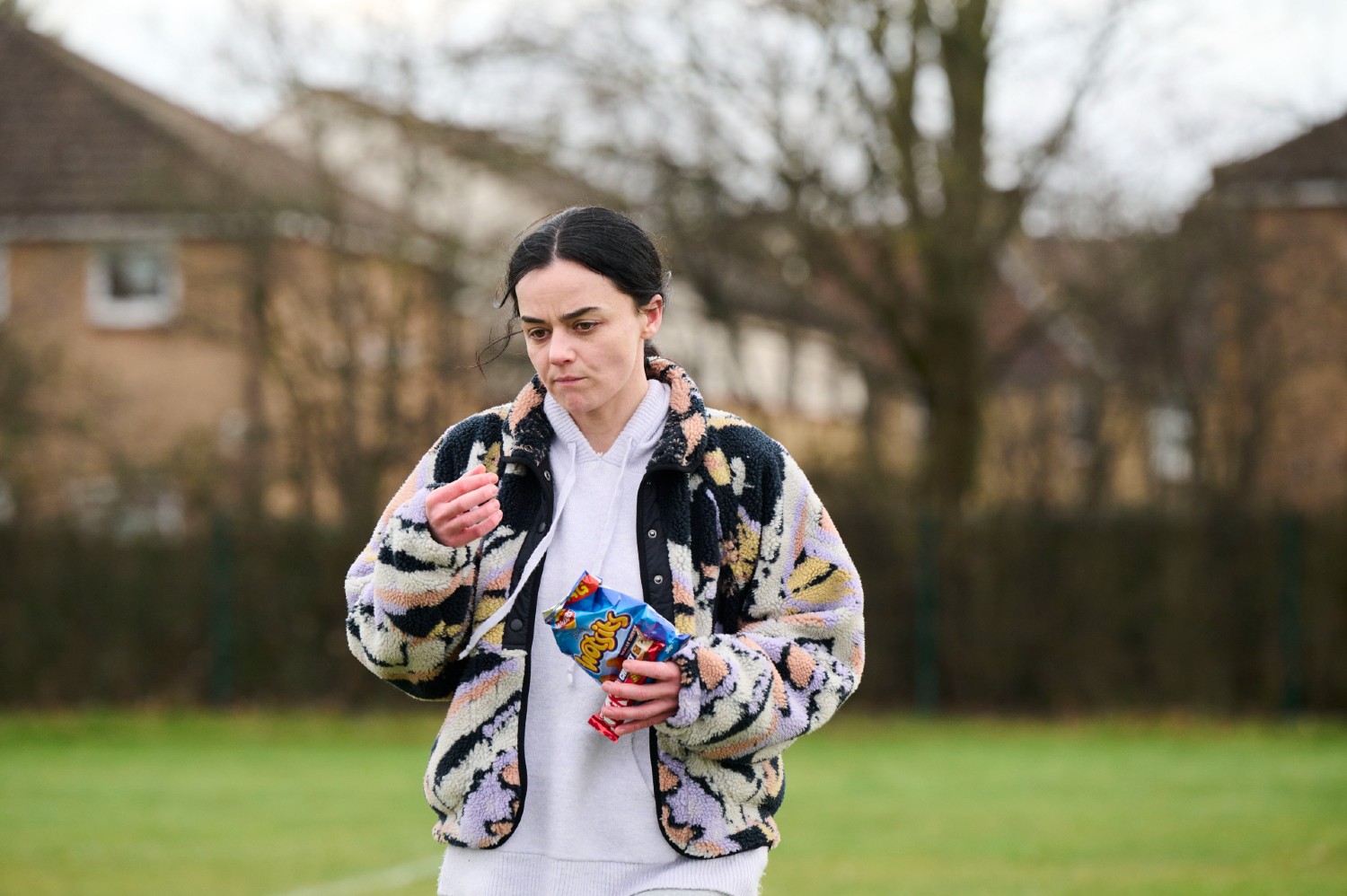 Hayley Squires eating a packet of crisps