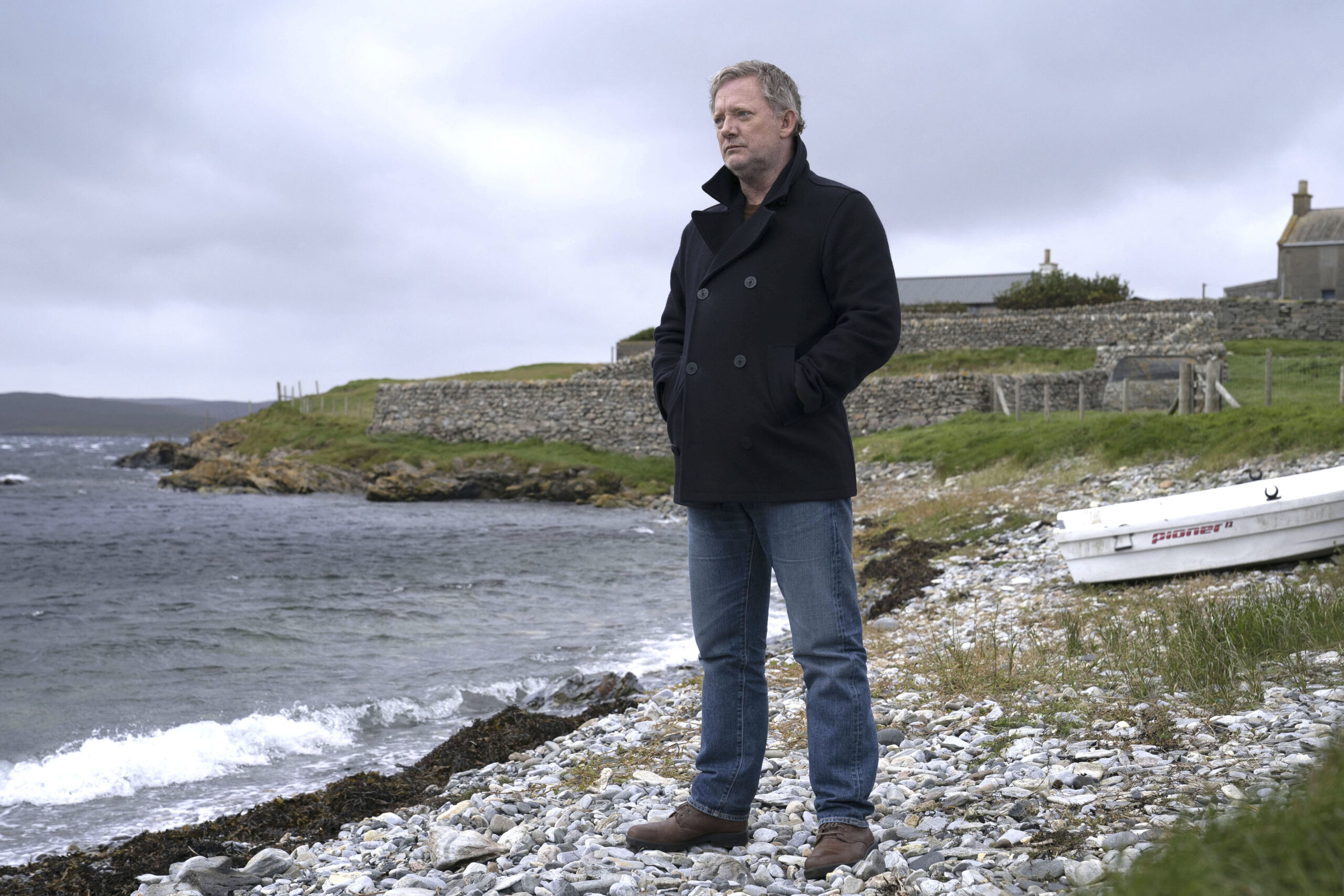 Douglas Henshall as DI Perez on a stony beach in Shetland Season 7