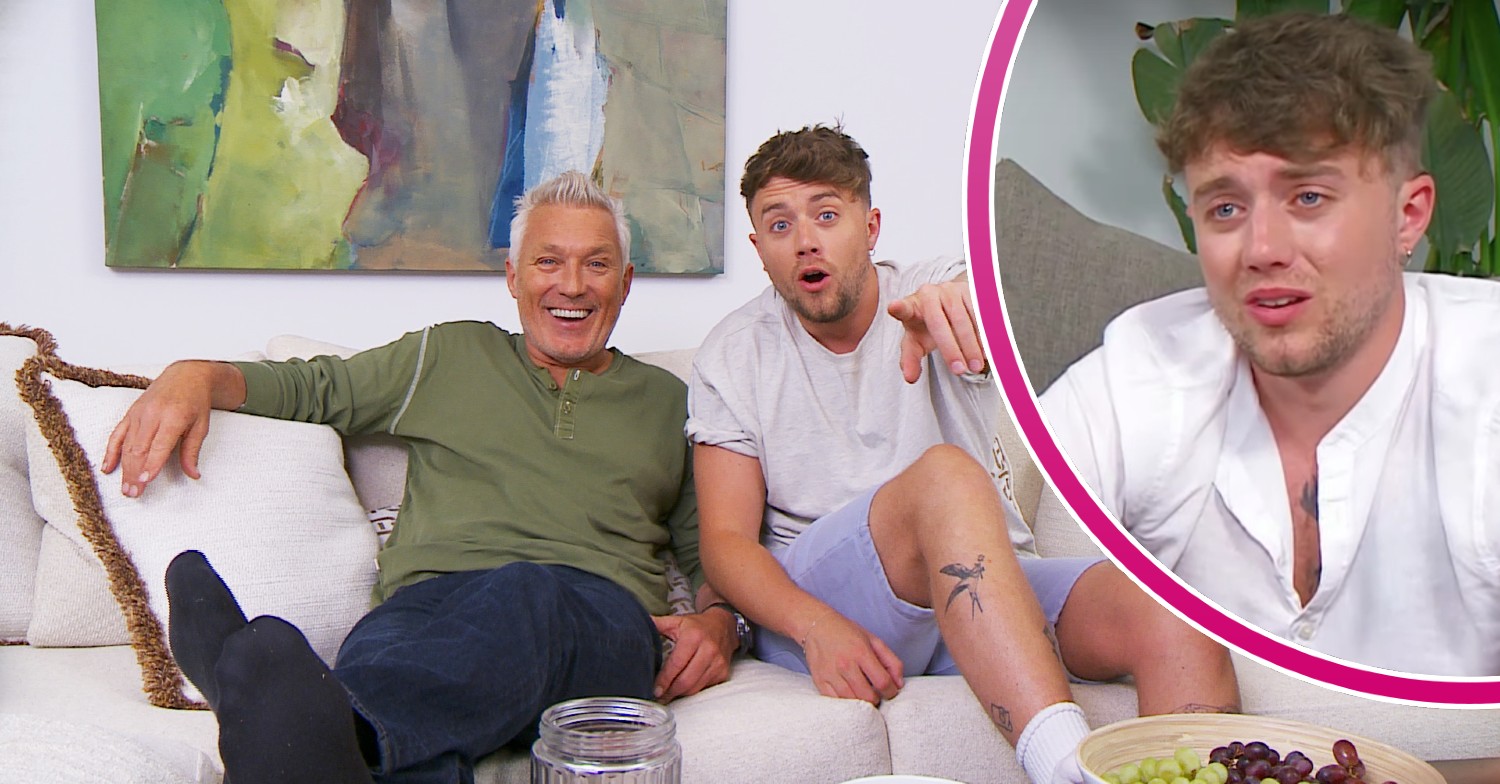Martin and Roman Kemp smiling and pointing at the TV on Celebrity Gogglebox