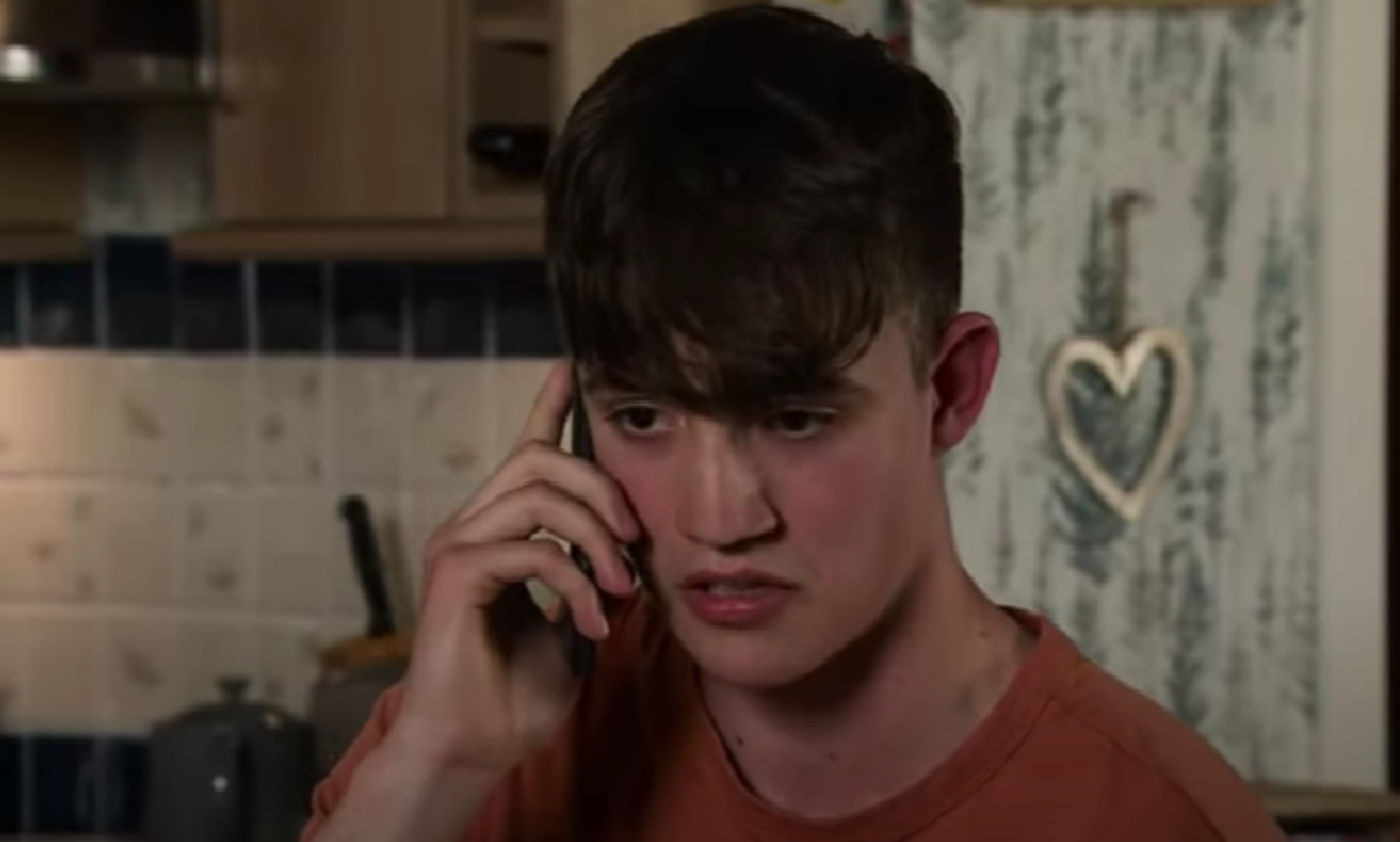 Aaron on the phone in Corrie 