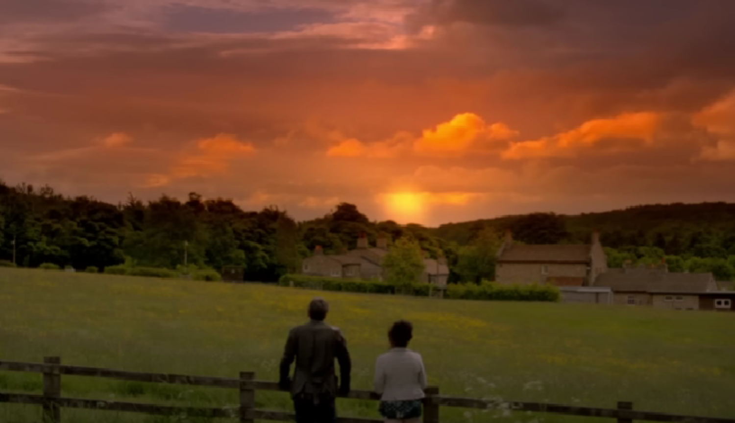 Cain and Faith watch the sunrise in a field Emmerdale 