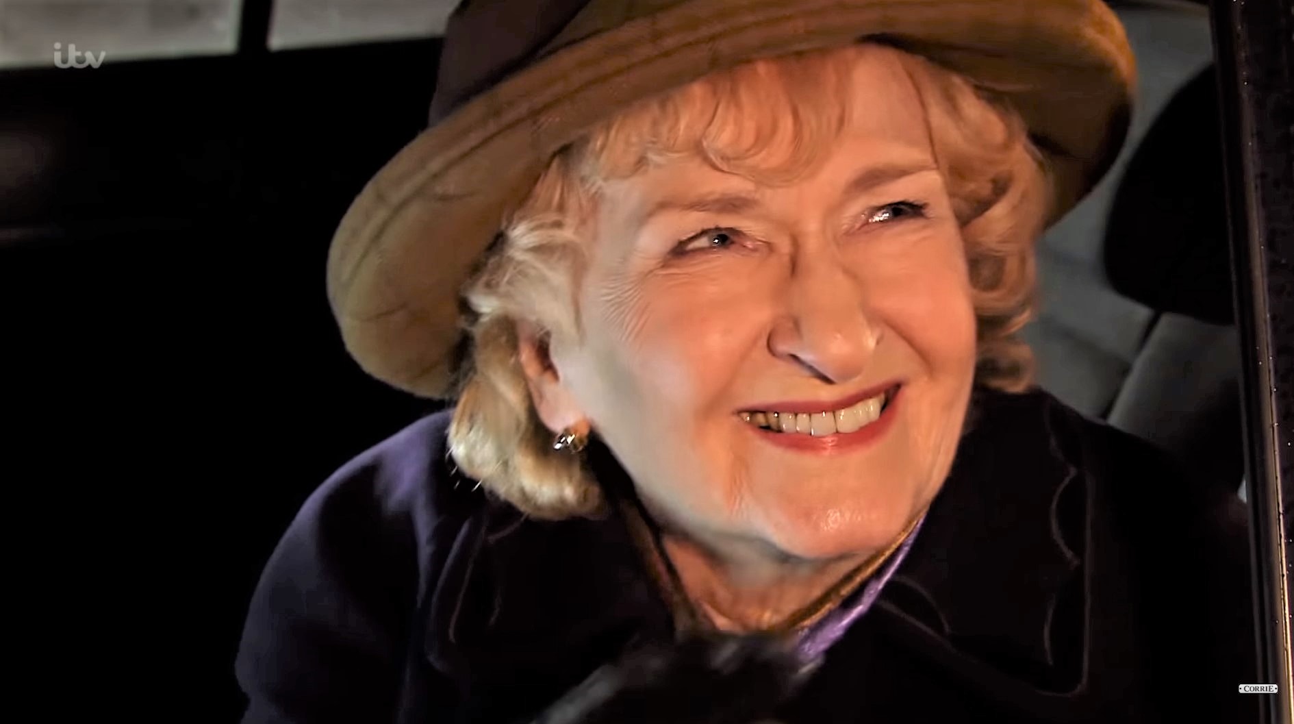Emily Bishop smiles as she leaves Coronation Street in a cab for Peru