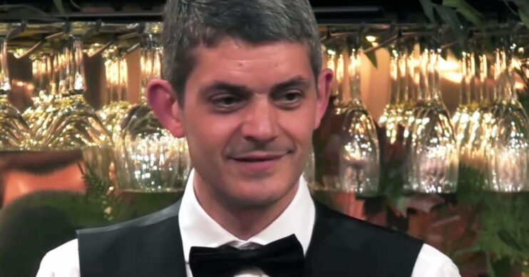First Dates star Merlin Griffiths smiles behind the bar