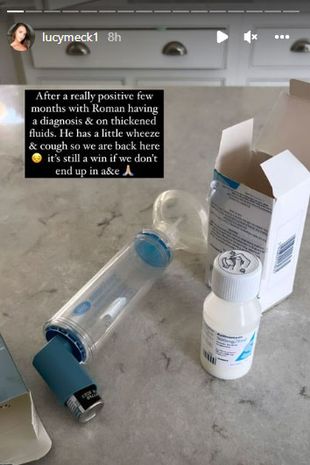  Lucy Mecklenburgh's instagram story. The image shows a child's inhaler and a bottle of medicine on a kitchen counter. There is a black text box with white writing which reads "After a really positive few months with Roman having a diagnosis and on thickened fluids, he has a little wheeze (sad looking down emoji). It's still a win if we don't end up in A&E (prayer hands emoji)"