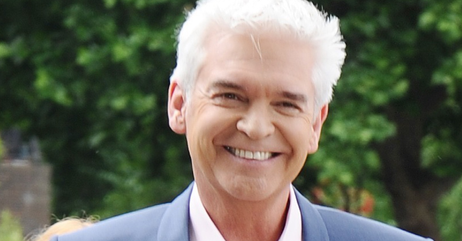 This Morning star Phillip Schofield smiling at an event in a navy suit