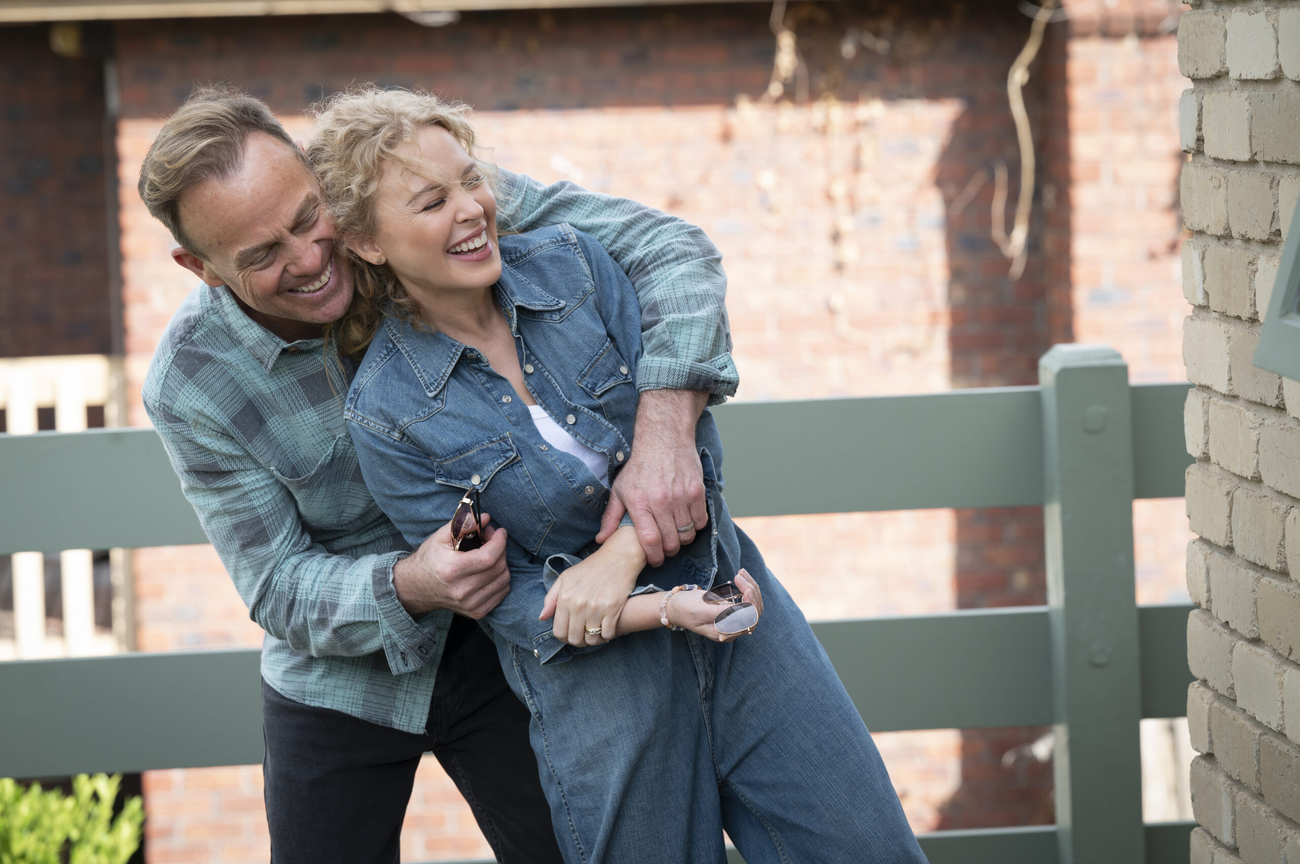 Scott and Charlene hug and smile in Neighbours