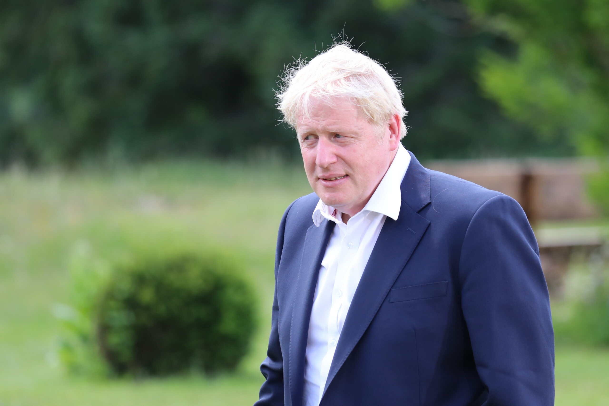 Boris Johnson wearing a blue suit looking confused