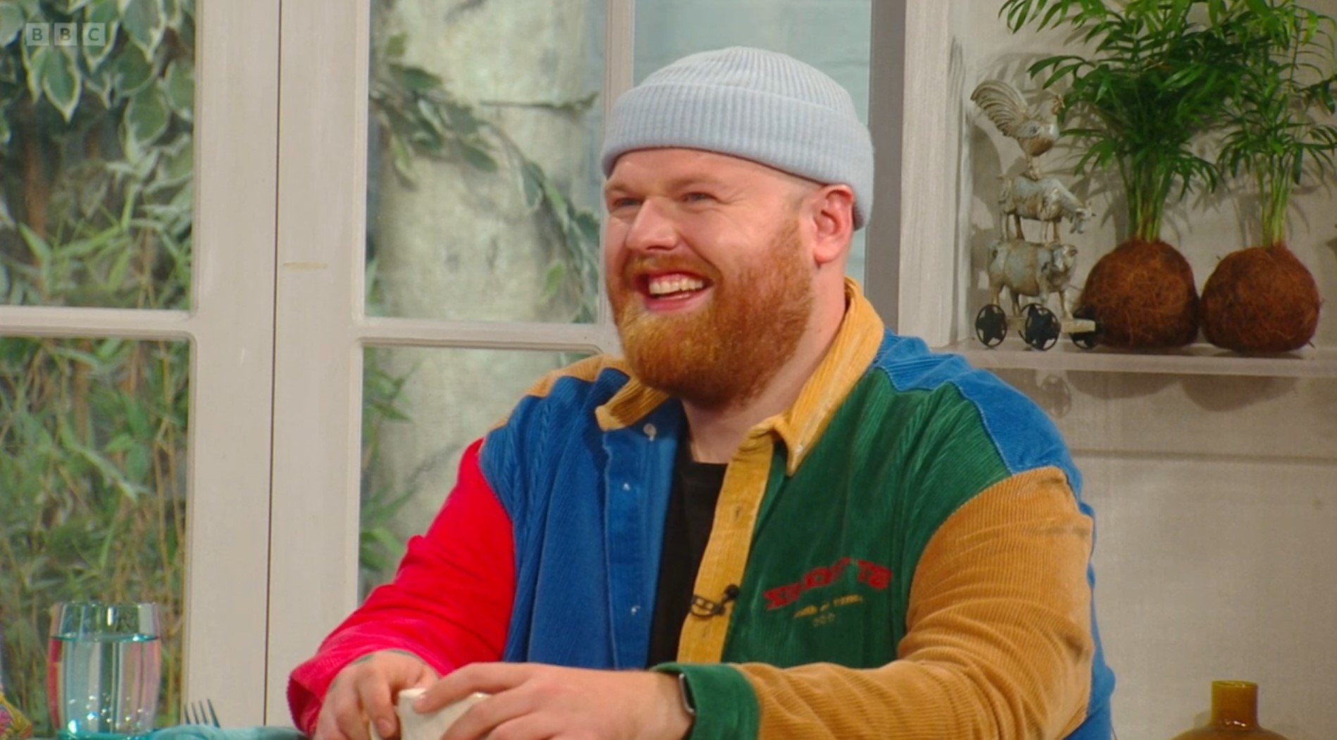 Tom Walker smiles in beanie hat on Saturday Kitchen