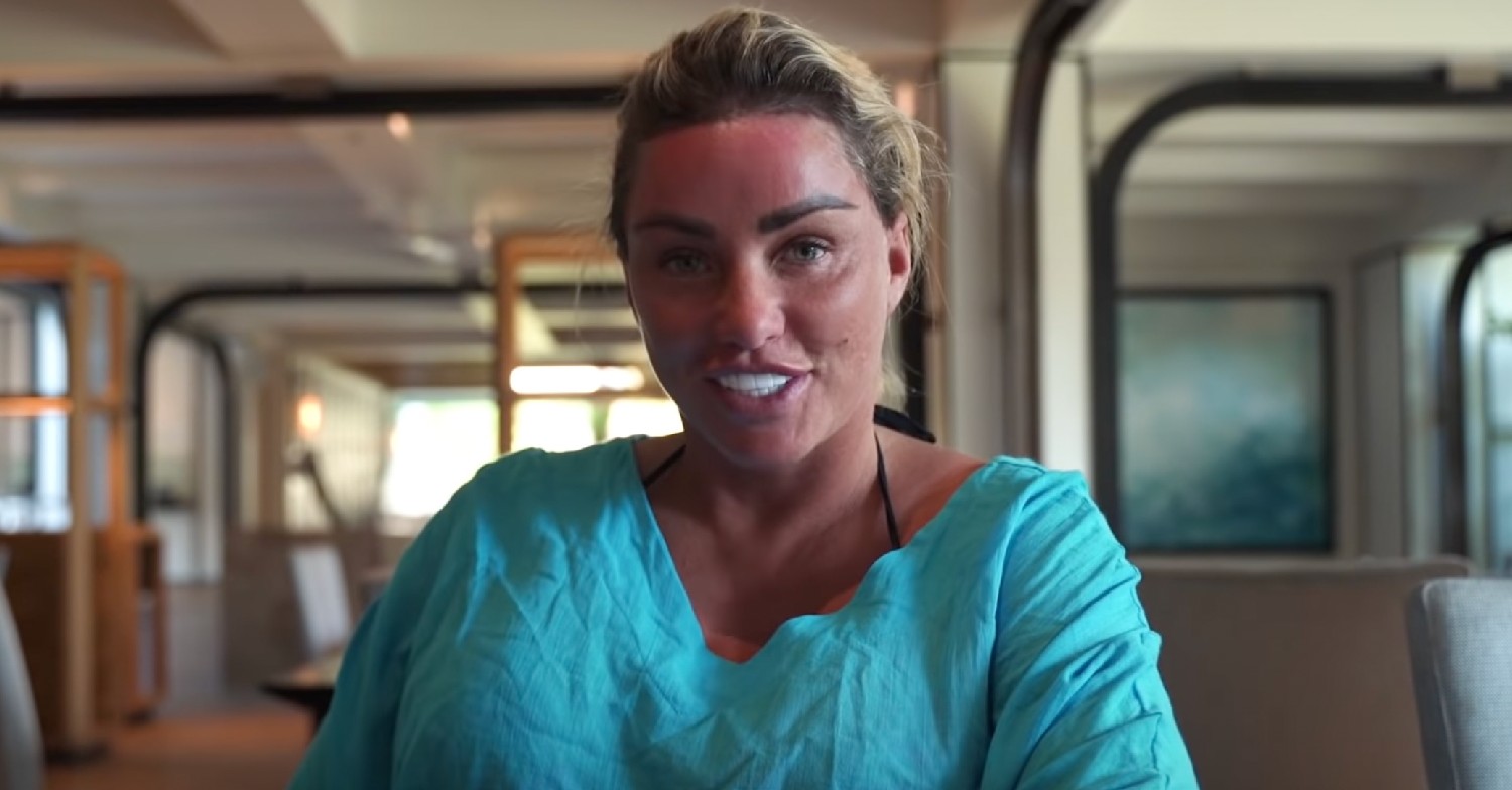 Katie Price smiling in an aqua top