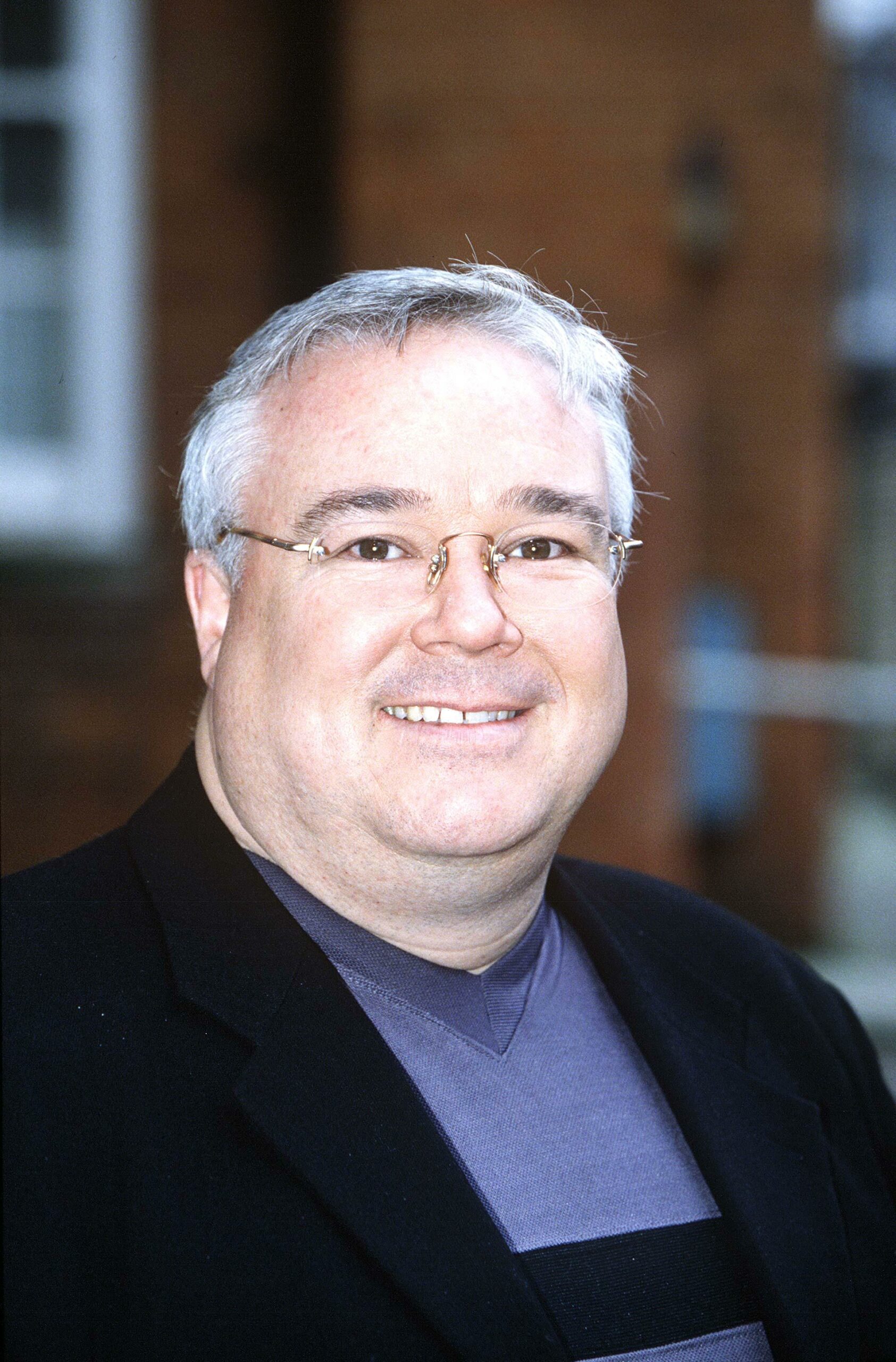 Michael Starke smiling wearing glasses