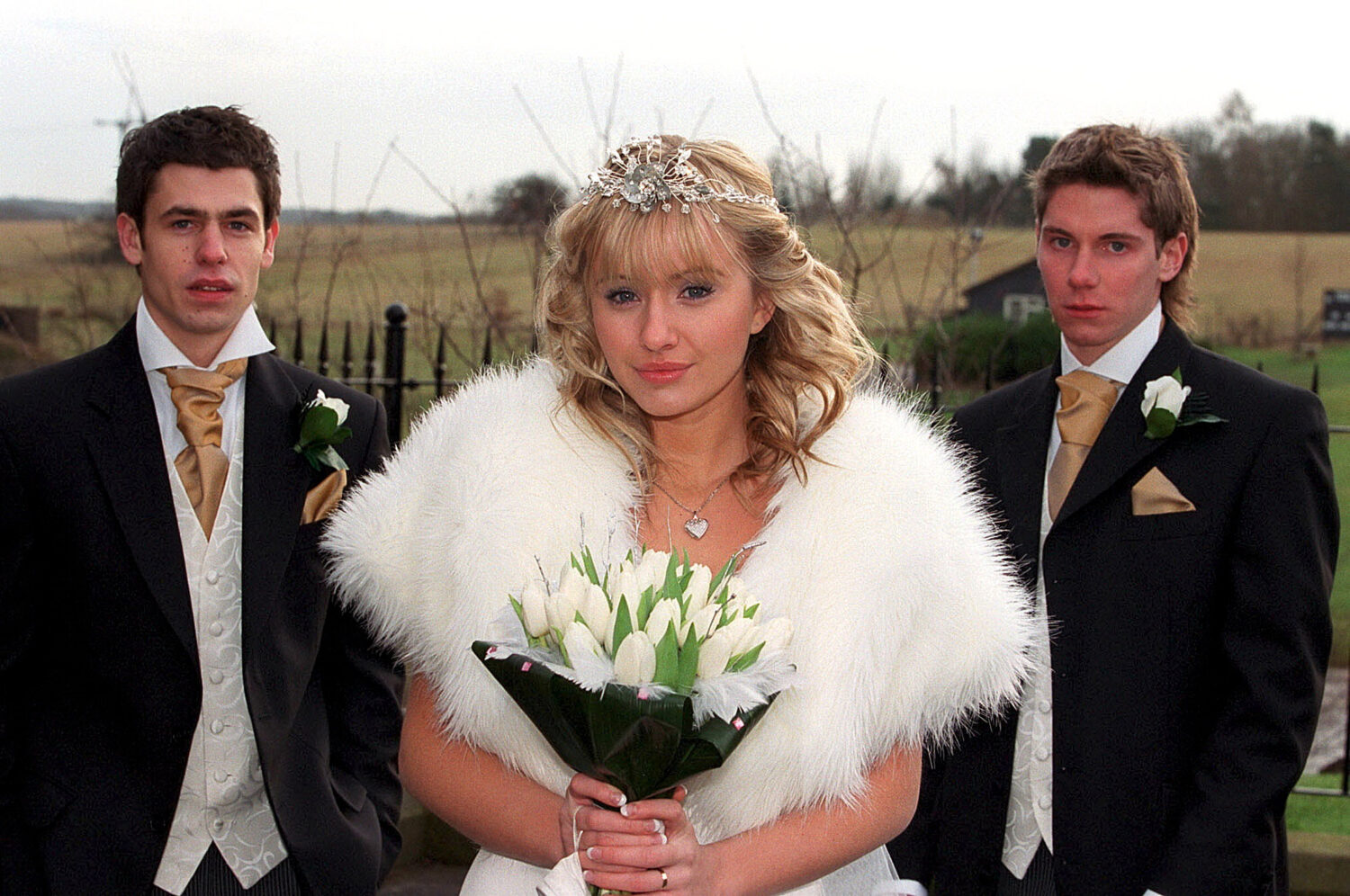 Robert Katie and Andy pose for press shot on Andy and Katie's wedding day looking serious