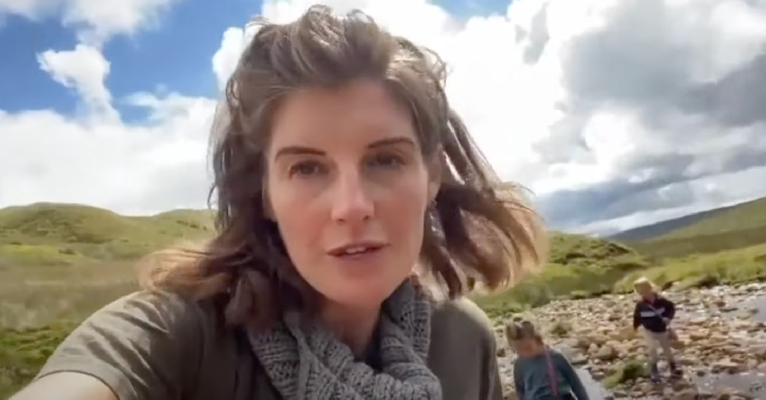Amanda Owen on hills with children wearing a scarf